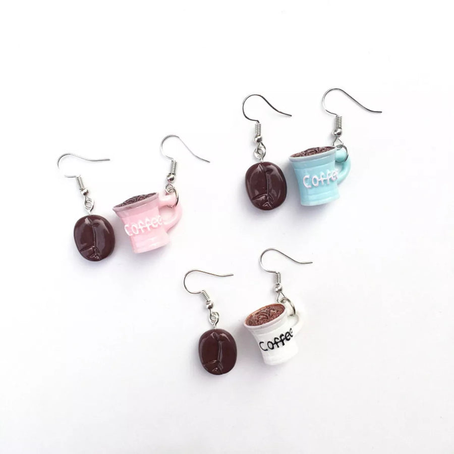Coffee bean and cup drop earrings in ivory, pastel blue, and blush pink.