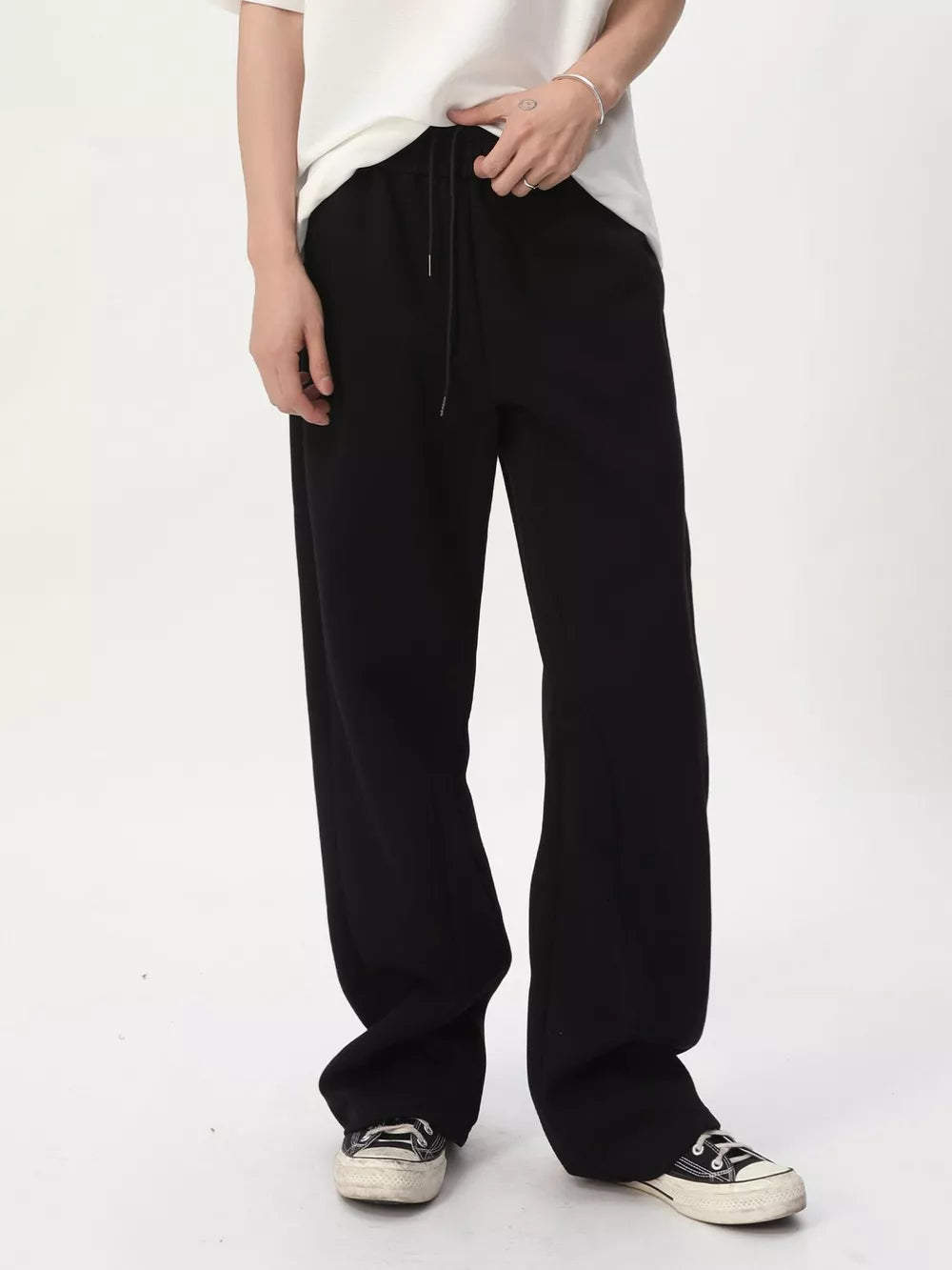 Black relaxed fit sweatpants with adjustable drawstring waist and wide leg