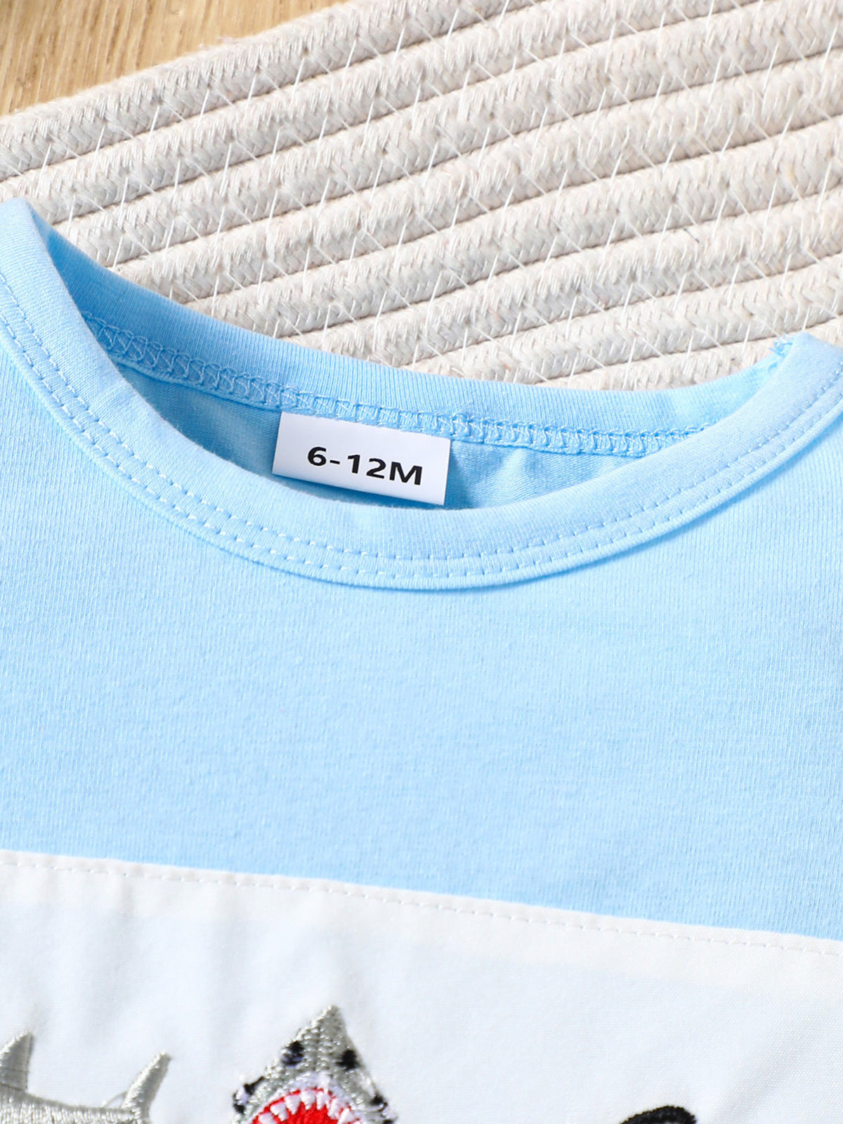 Baby t-shirt and shorts set in pastel blue and white with embroidered sharks.