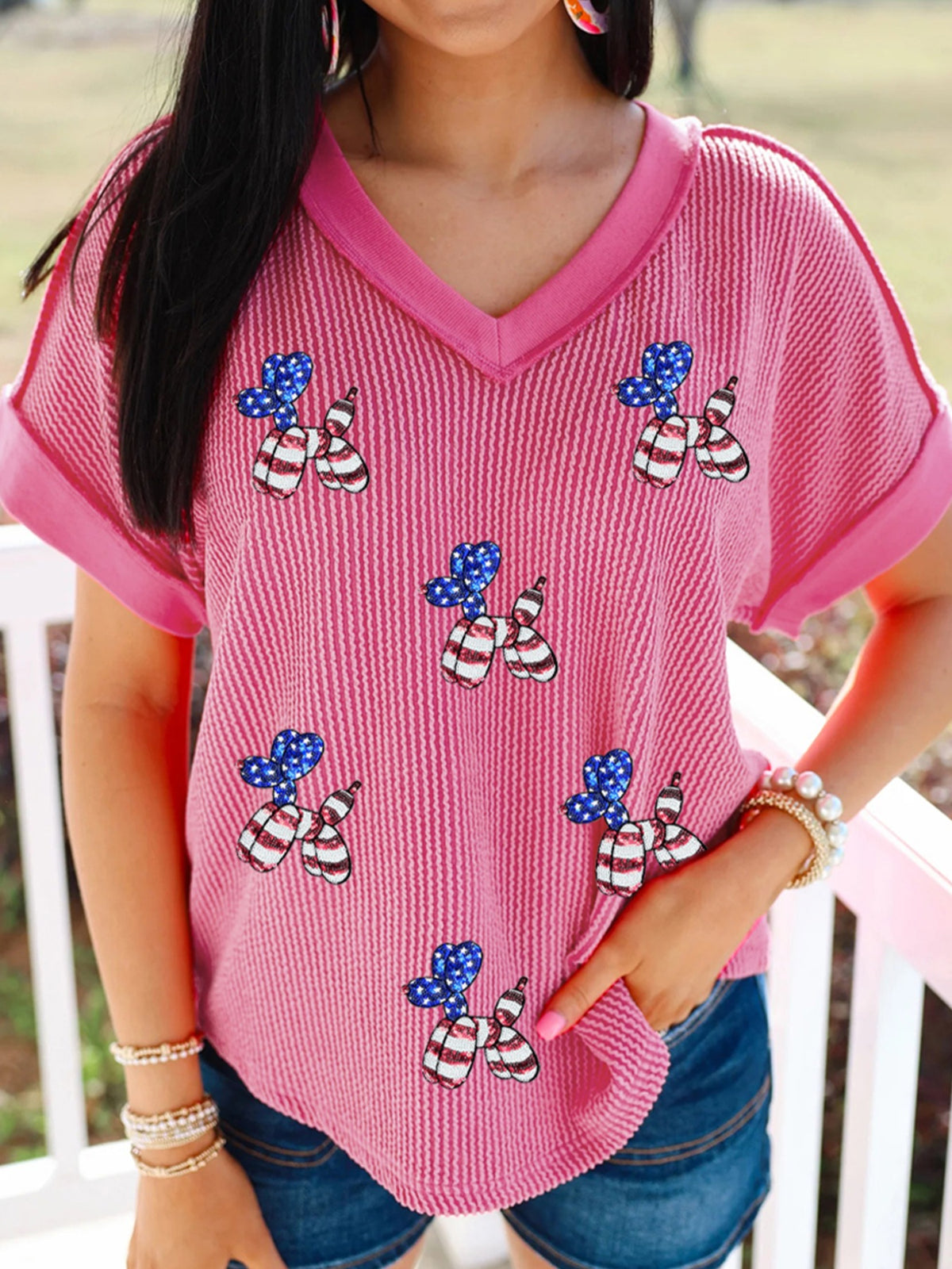 Pink striped V-neck tee with patriotic sequin balloon dog graphic and cuffed sleeves.
