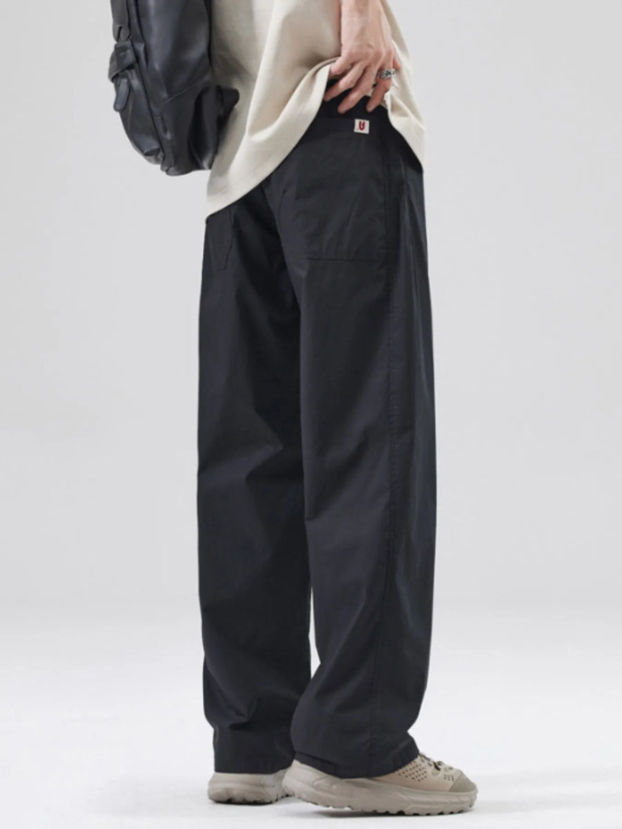 Black oversized casual pants with a loose fit and cotton blend material.