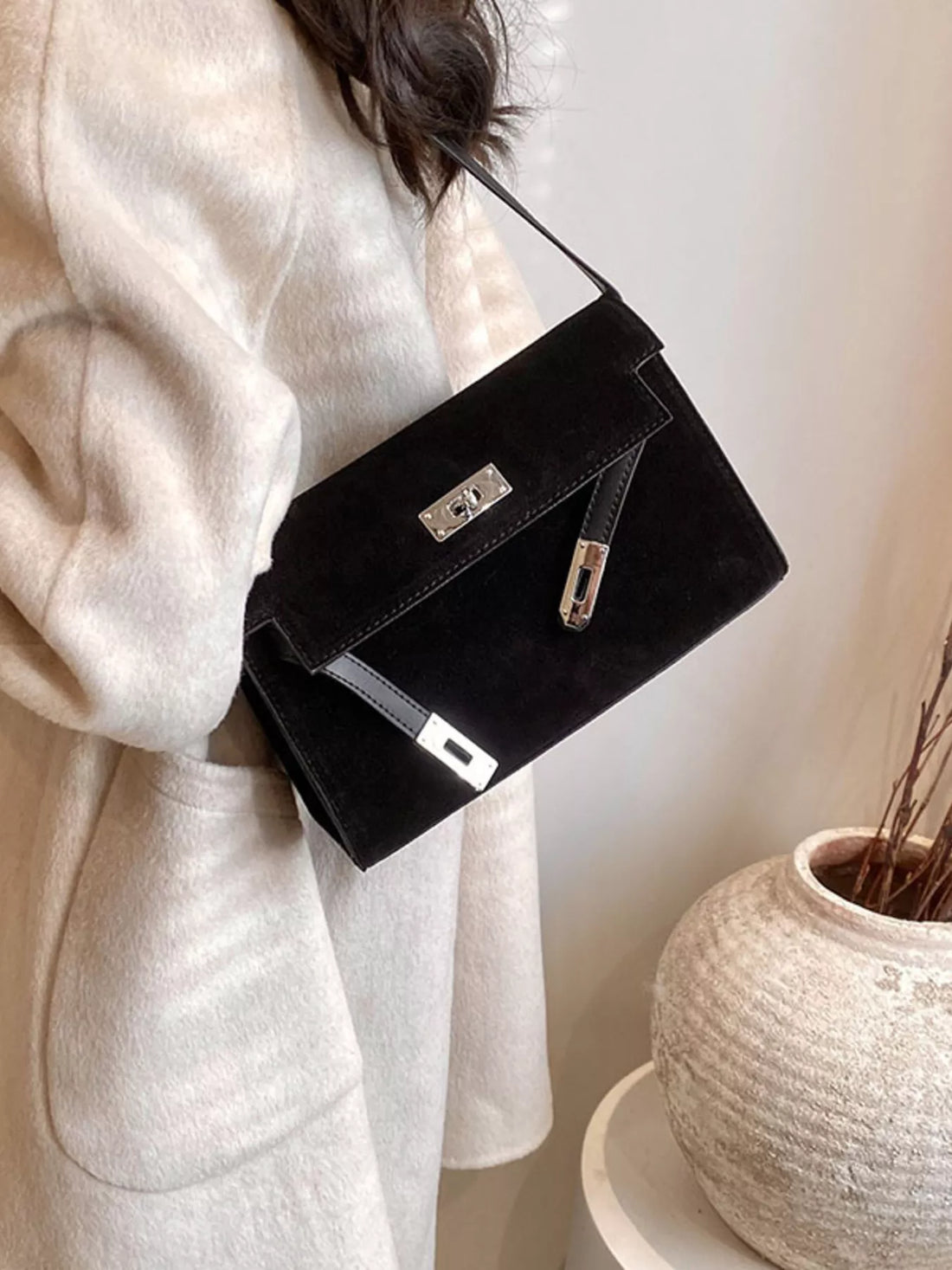 Black suede shoulder bag with silver buckle detail and leather trim