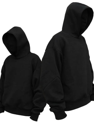 Black oversized hooded sweatshirt with drop shoulders and ribbed cuffs.