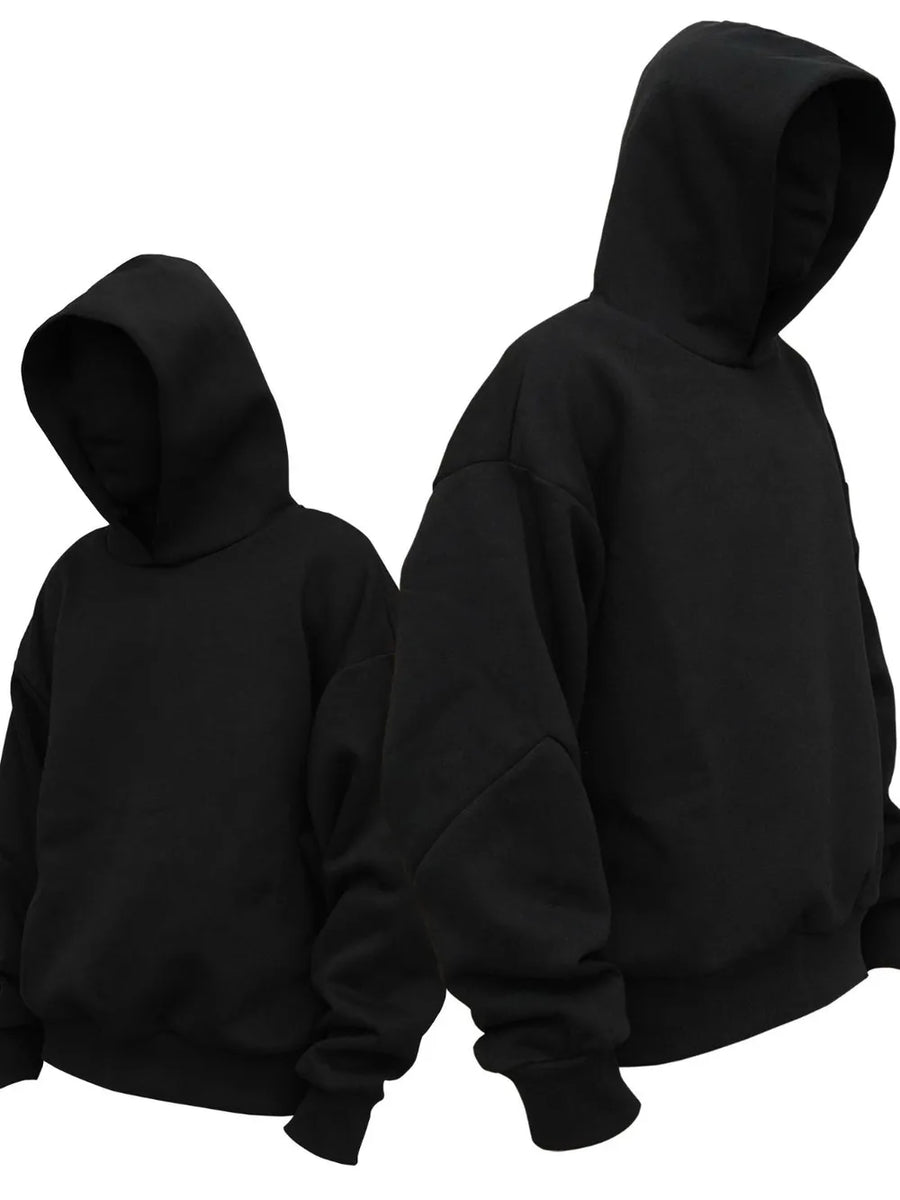 Black oversized hooded sweatshirt with drop shoulders and ribbed cuffs.