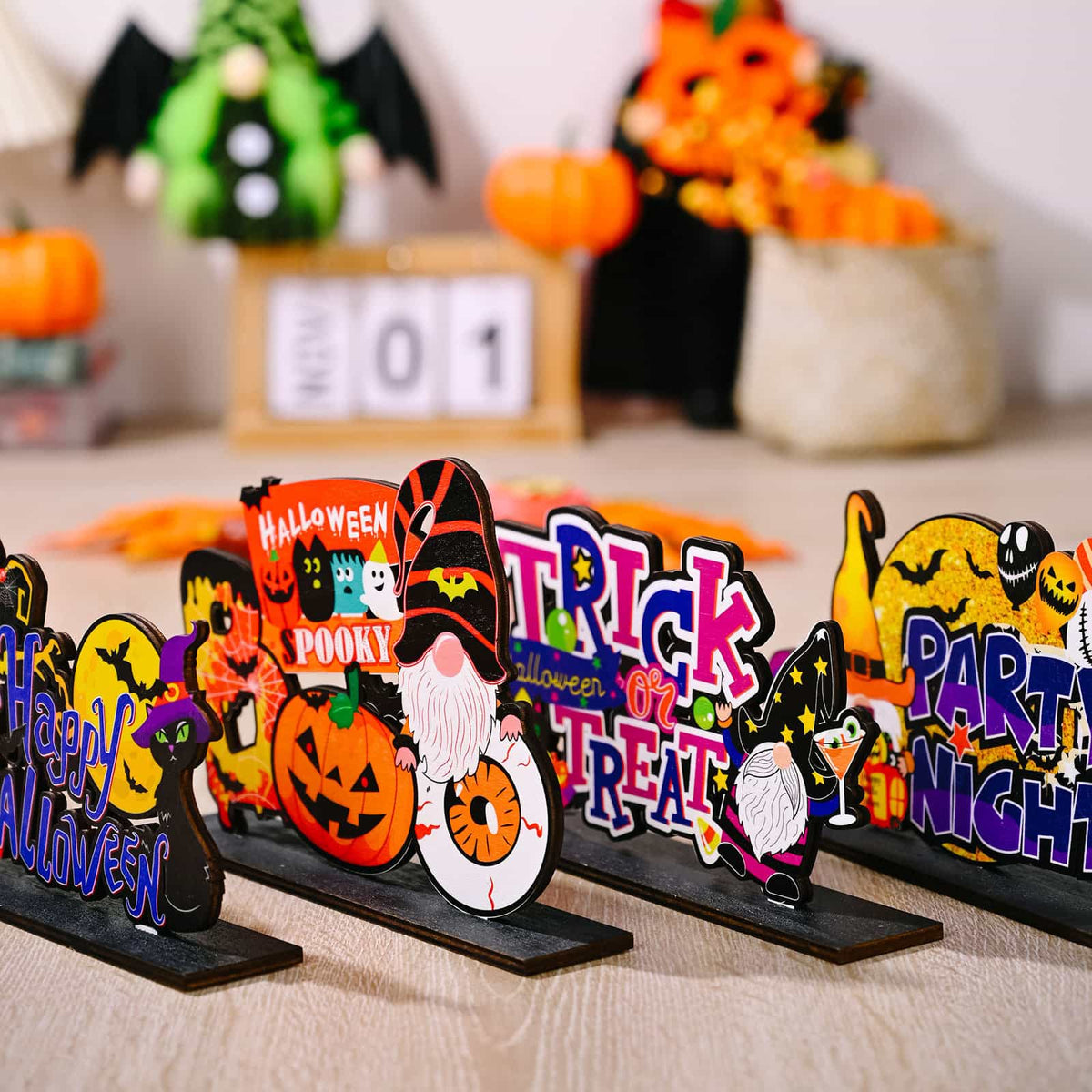 Spooky Scene Halloween tabletop decor with gnomes, pumpkins, and text.