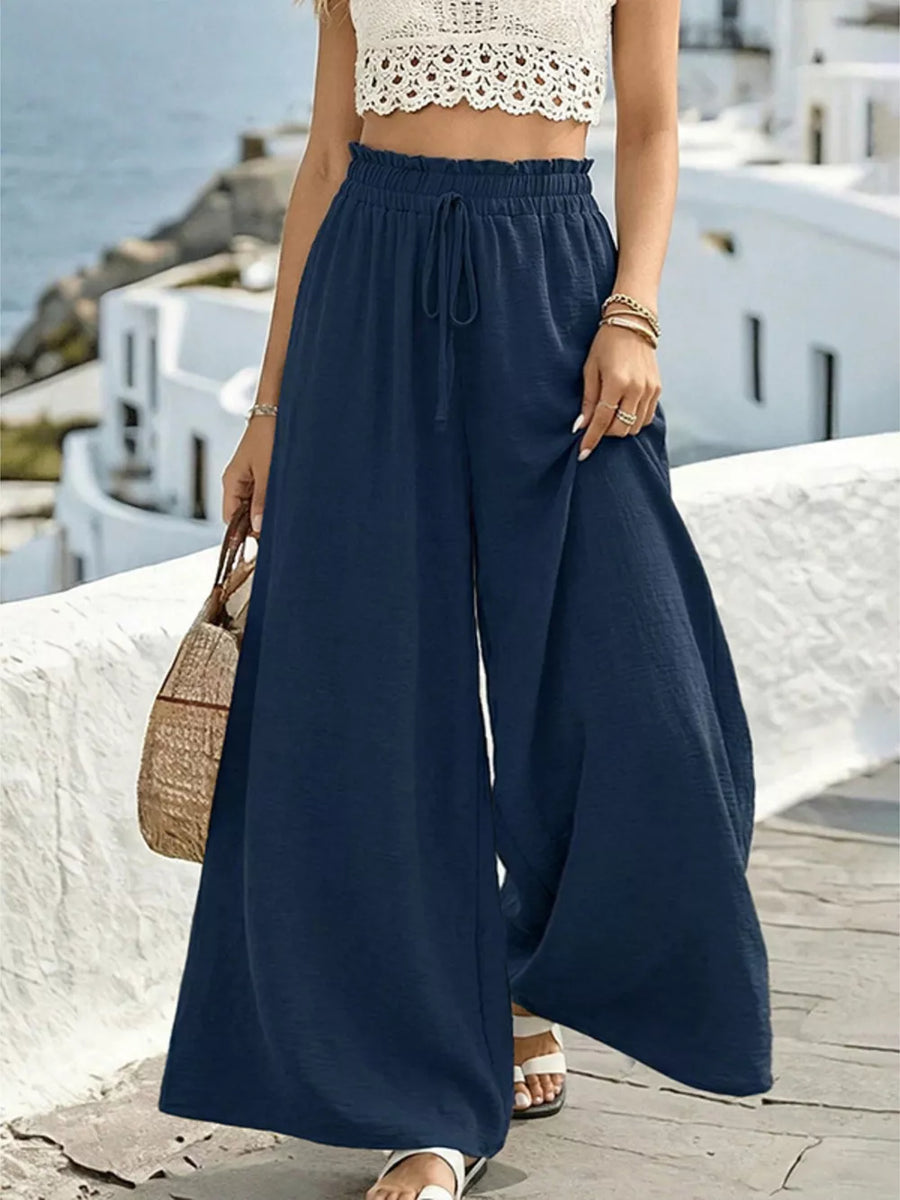 Navy wide-leg linen pants with drawstring waist and ruffled detail