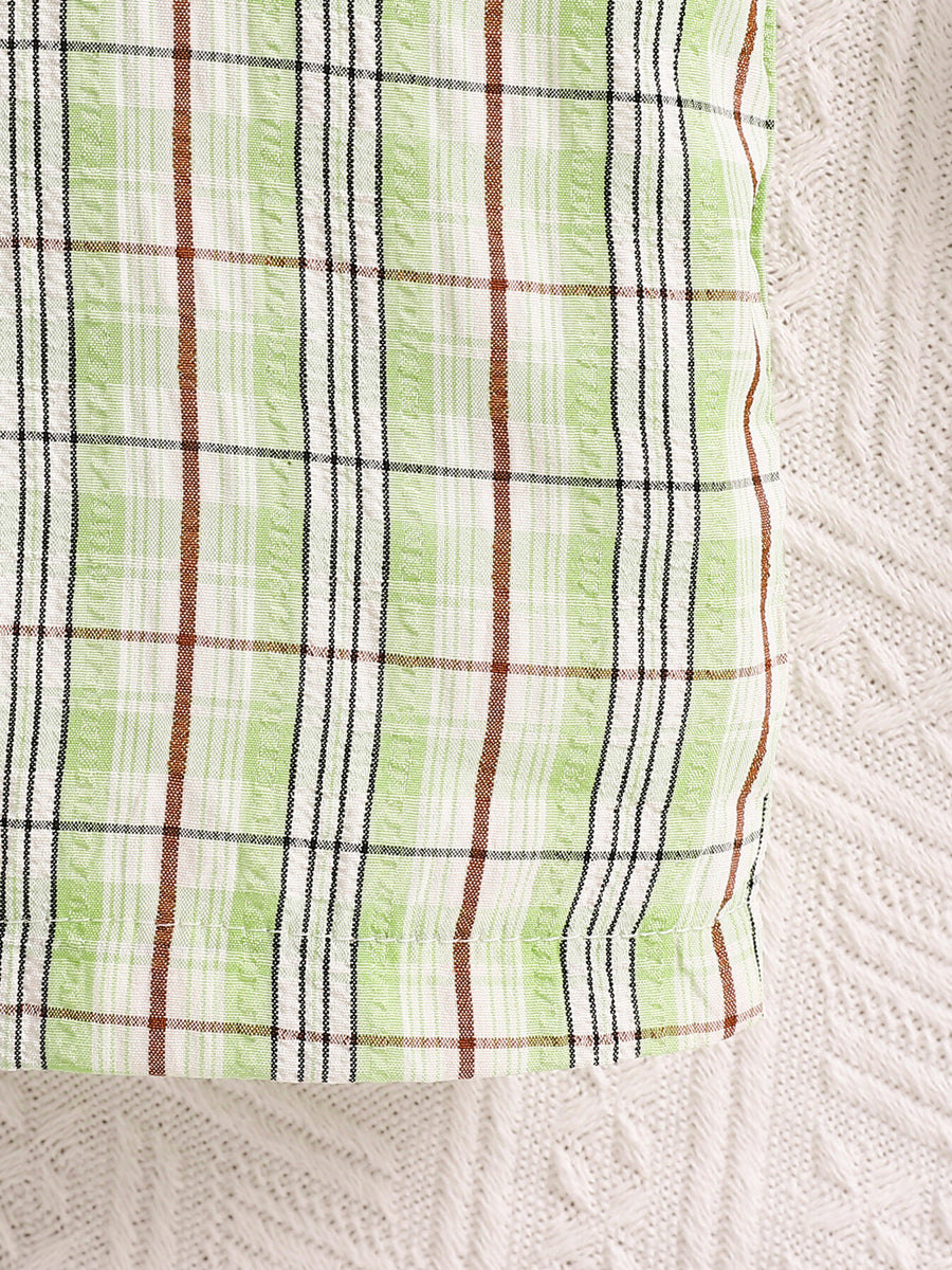 Children's green plaid overalls with adjustable straps detail