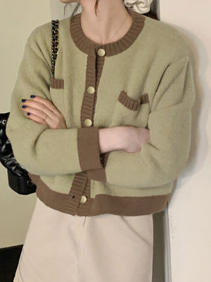 Green acrylic button up cardigan with contrast trim and gold buttons.