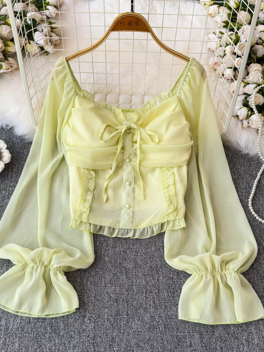 Yellow green sheer maternity blouse with ruffled sleeves, bow detail and buttons