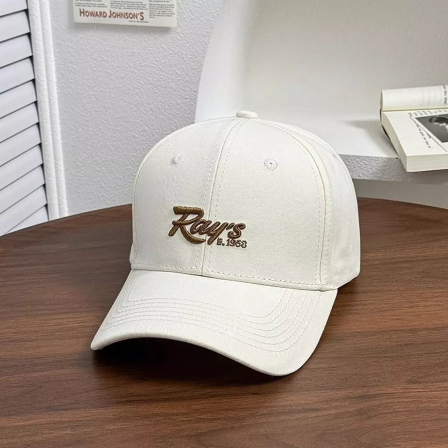 White baseball cap with embroidered "Ray's E. 1958" detail