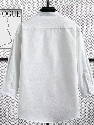 White textured long sleeve button-up shirt with a classic collar and button cuffs.