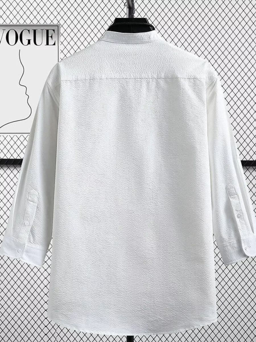 White textured long sleeve button-up shirt with a classic collar and button cuffs.