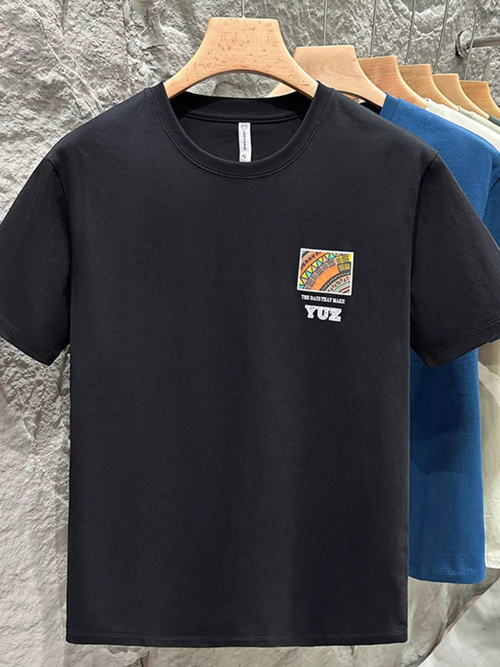 Black cotton crew t-shirt with abstract graphic detail and text.