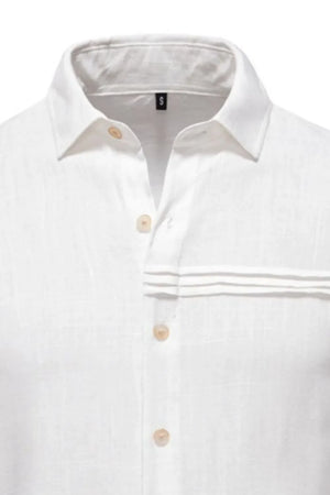 White linen shirt with buttoned collar, pleated pocket detail, and natural buttons.