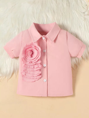 Pink toddler shirt with floral appliqué and white buttons