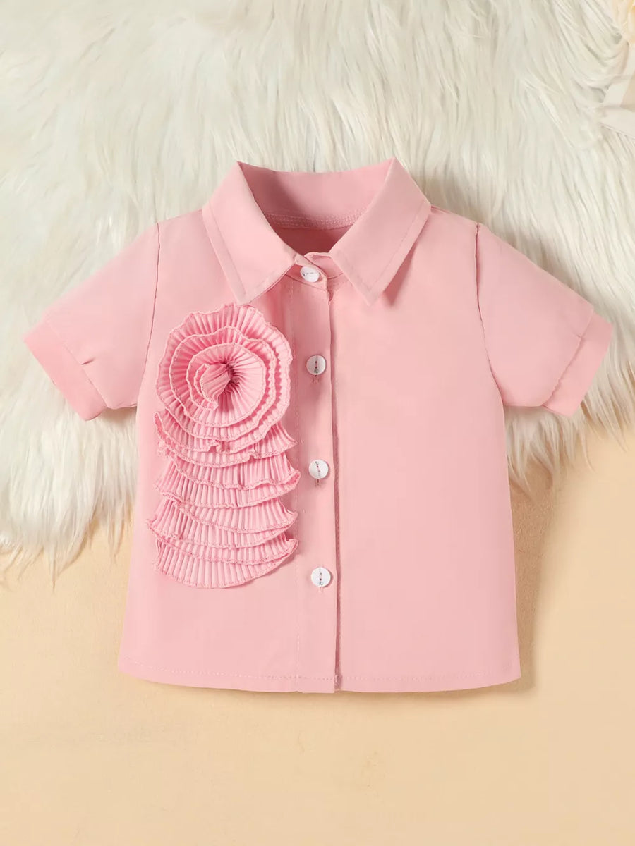Pink toddler shirt with floral appliqué and white buttons