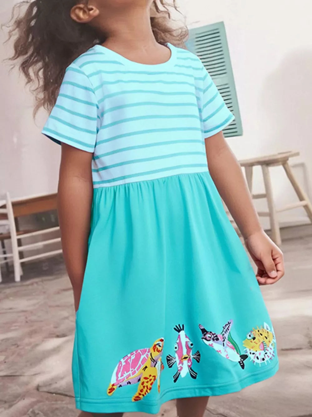 Baby girl's aqua marine striped cotton dress with embroidered sea life hem.