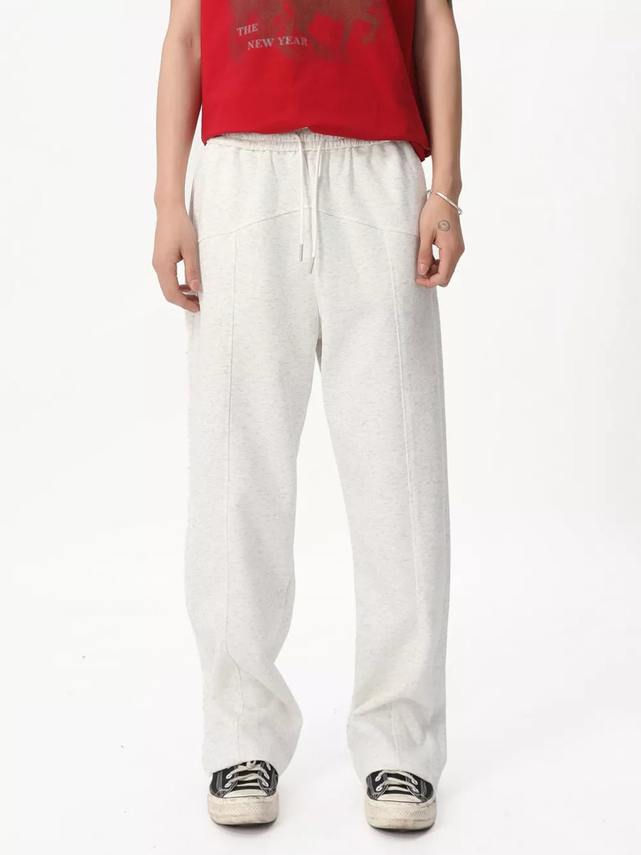 Cream cotton sweatpants with drawstring and wide legs.