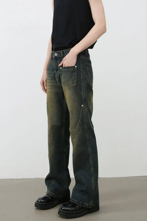 Dark wash bootcut jeans with faded seam details and a distressed look.