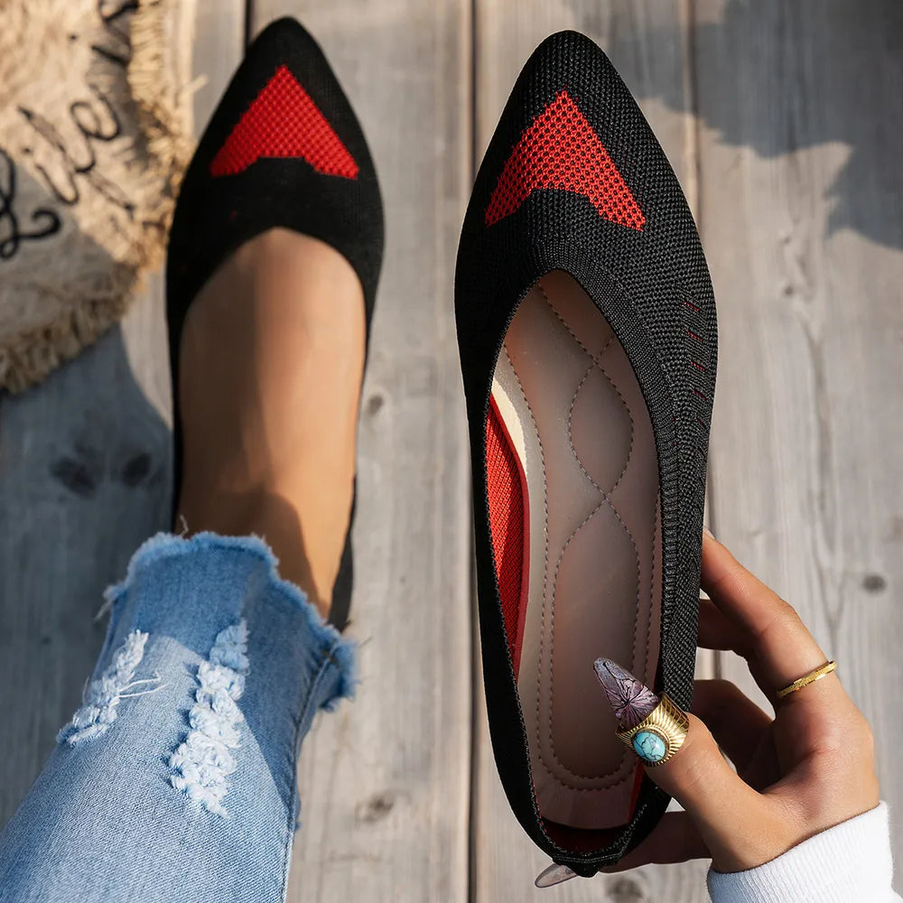 Black knit pointed flats with red geometric detail and cushioned insole.