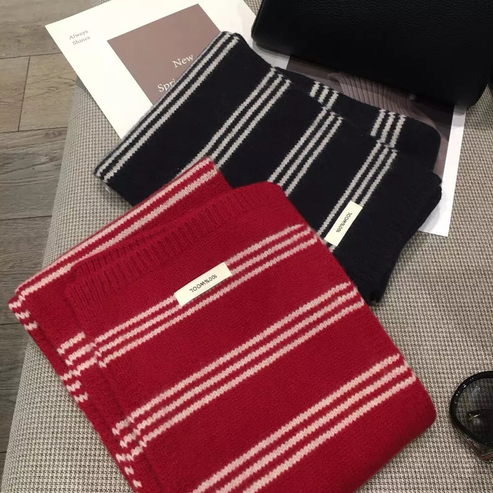 Contrast striped wool knit scarf in red and black with white stripes.