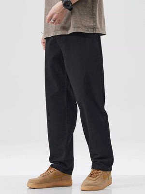 Black cotton pants with a relaxed fit, styled with a t-shirt and sneakers.