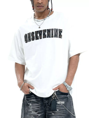 White cotton oversized t-shirt with black textured logo graphic on chest.
