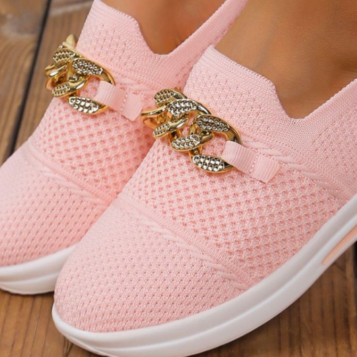 Pink mesh slip-on flats with chunky gold chain detail.