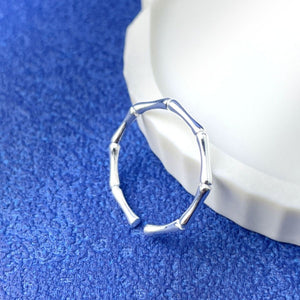 Silver ring featuring open design and branch motif