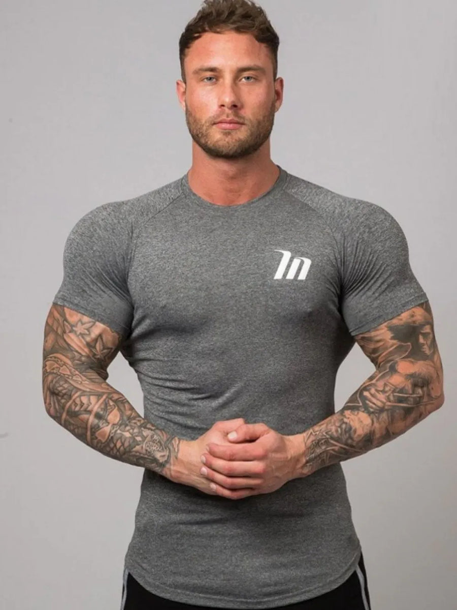 Dark Gray Performance Fit Raglan Tee with white logo and short sleeves.