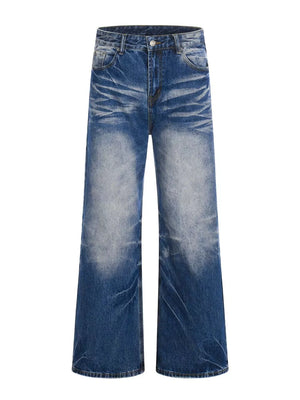 Men's light blue vintage wash wide leg jeans with distressed detailing.