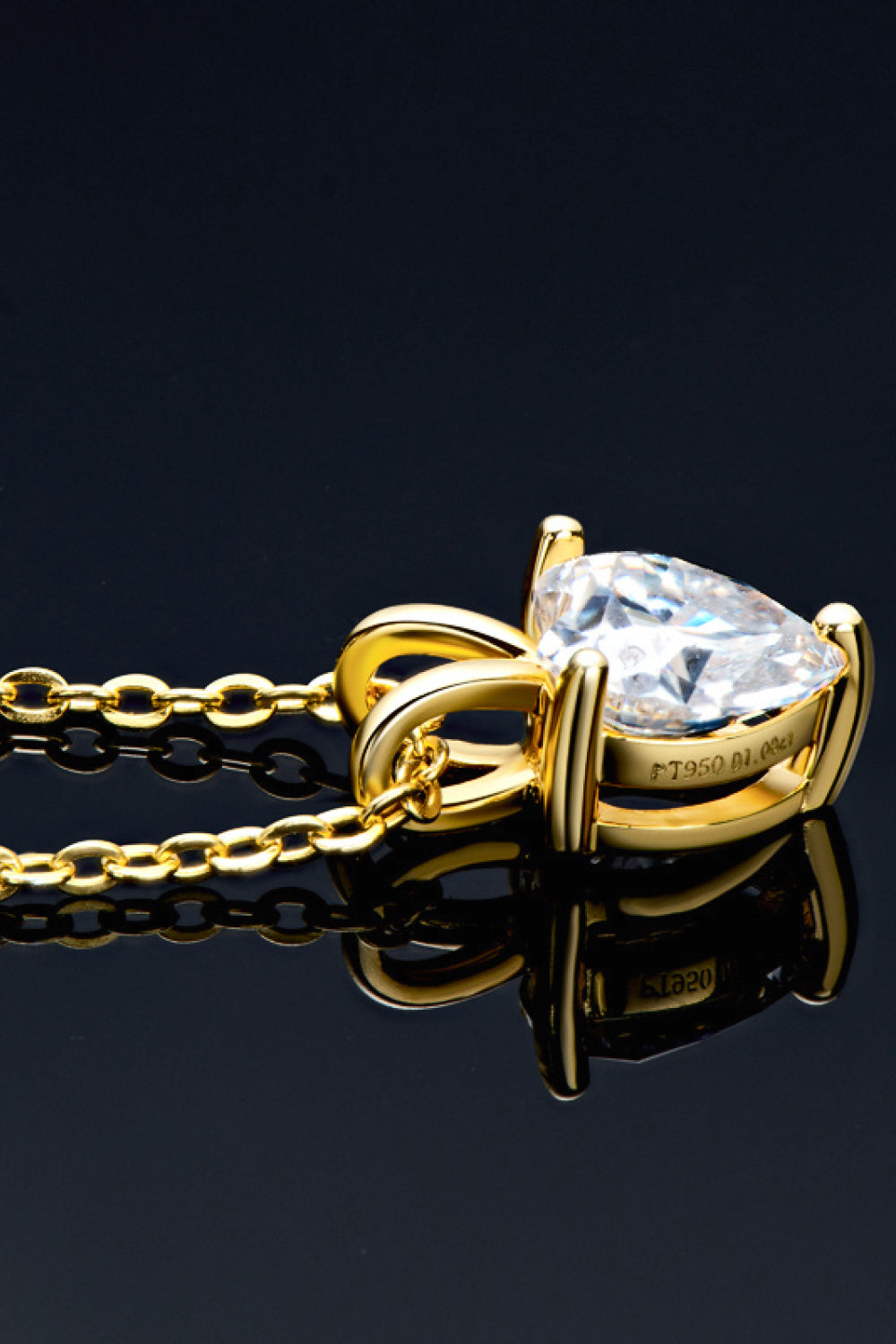Gold solitaire necklace with heart-cut moissanite and 18K gold-plated chain.