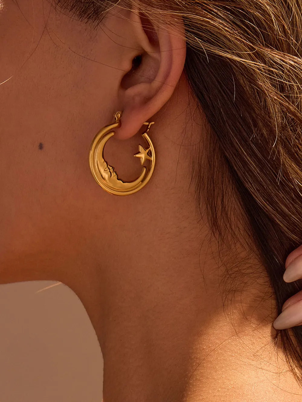 earrings in gold featuring crescent moon design and hoop fit