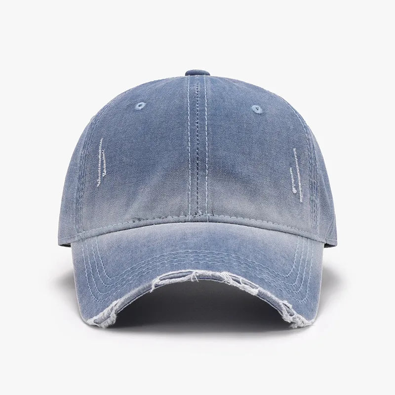 Faded denim baseball cap in Dusty Blue with distressed details and frayed brim.