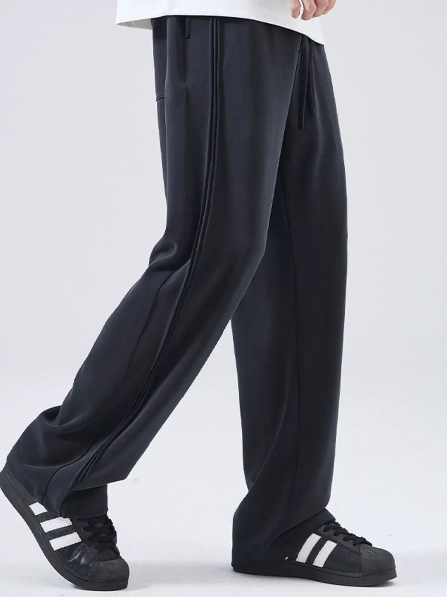 Black relaxed fit joggers with drawstring and side stripe detail.