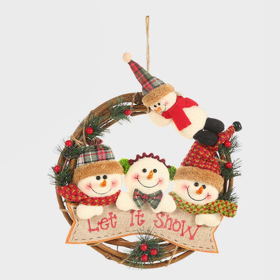 Festive wreath with plush snowmen characters and "Let It Snow" banner, decorated with pine and berries.