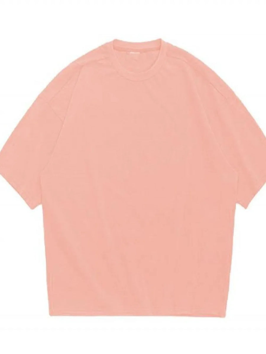 Oversized dusty pink crew neck t-shirt with textured fabric and short sleeves.