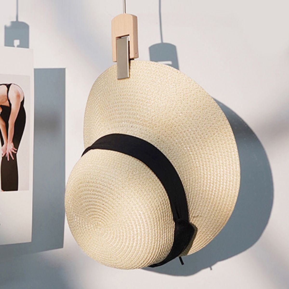 Beige woven straw wide brim sun hat with black ribbon band.
