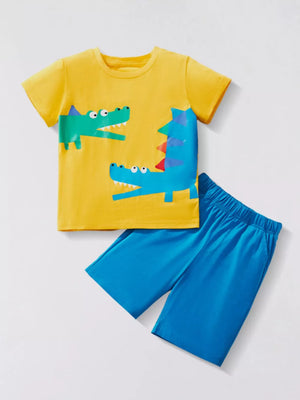 Kids yellow t-shirt with dinosaur print and blue shorts.