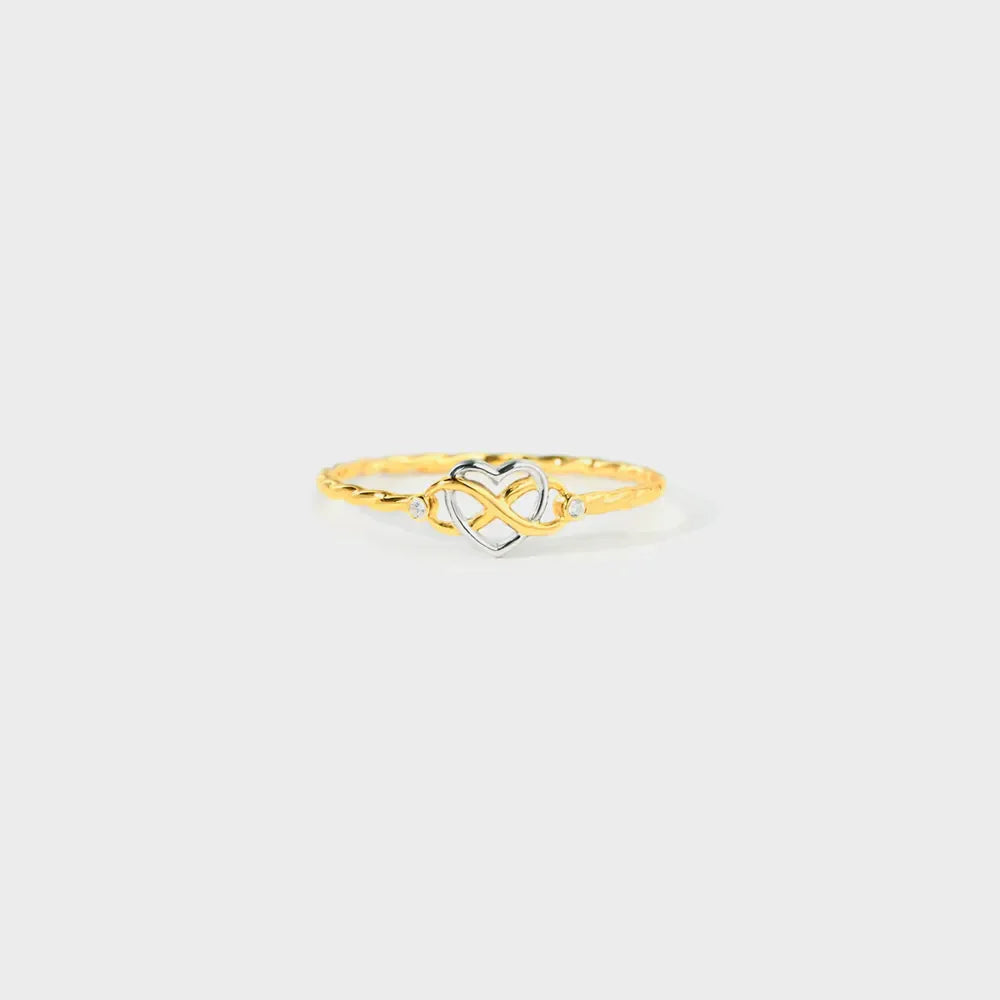Gold intertwined heart and infinity ring with diamond accents on a twisted band.