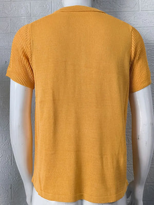 Textured knit polo shirt in mustard with short sleeves and a ribbed collar.