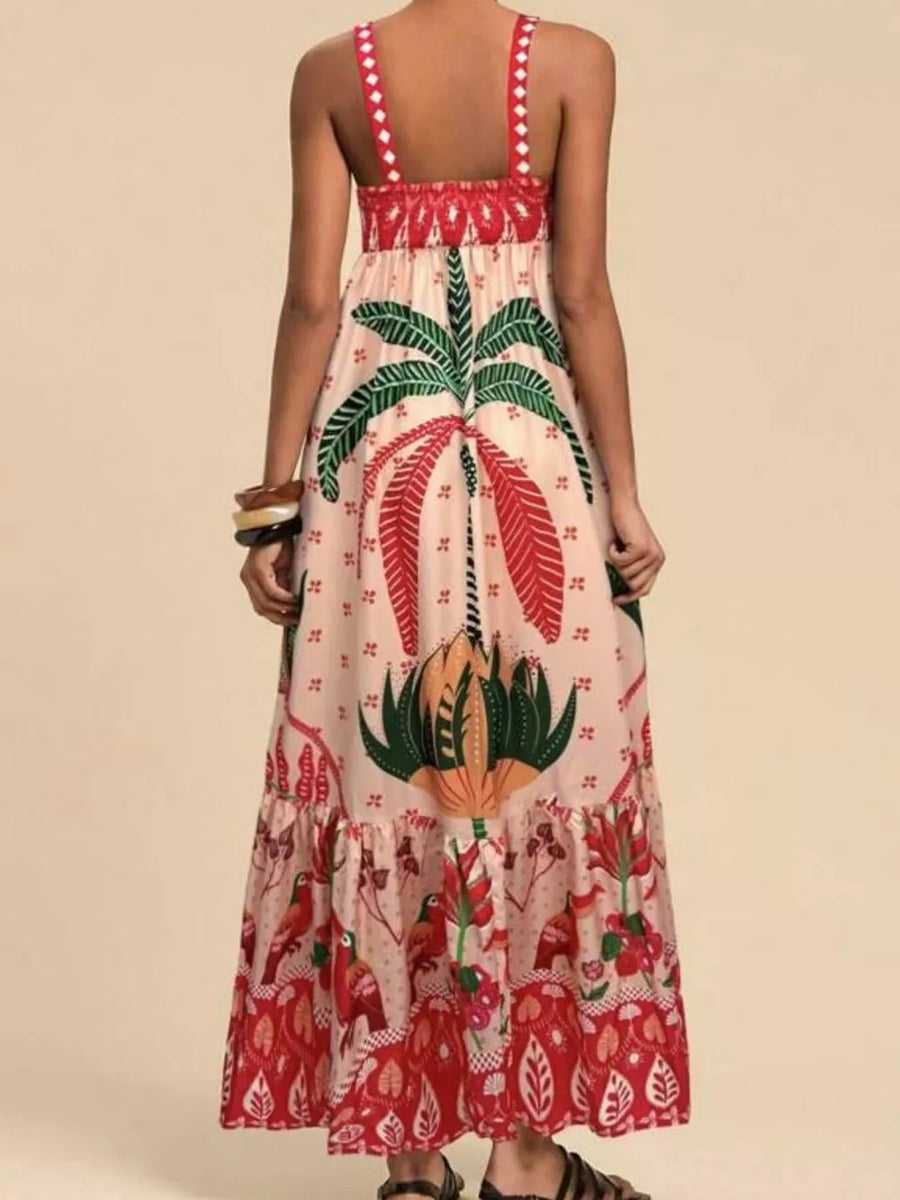 Tropical maxi dress with square neck, smocked bodice, and tiered hem in tan with red and green print.