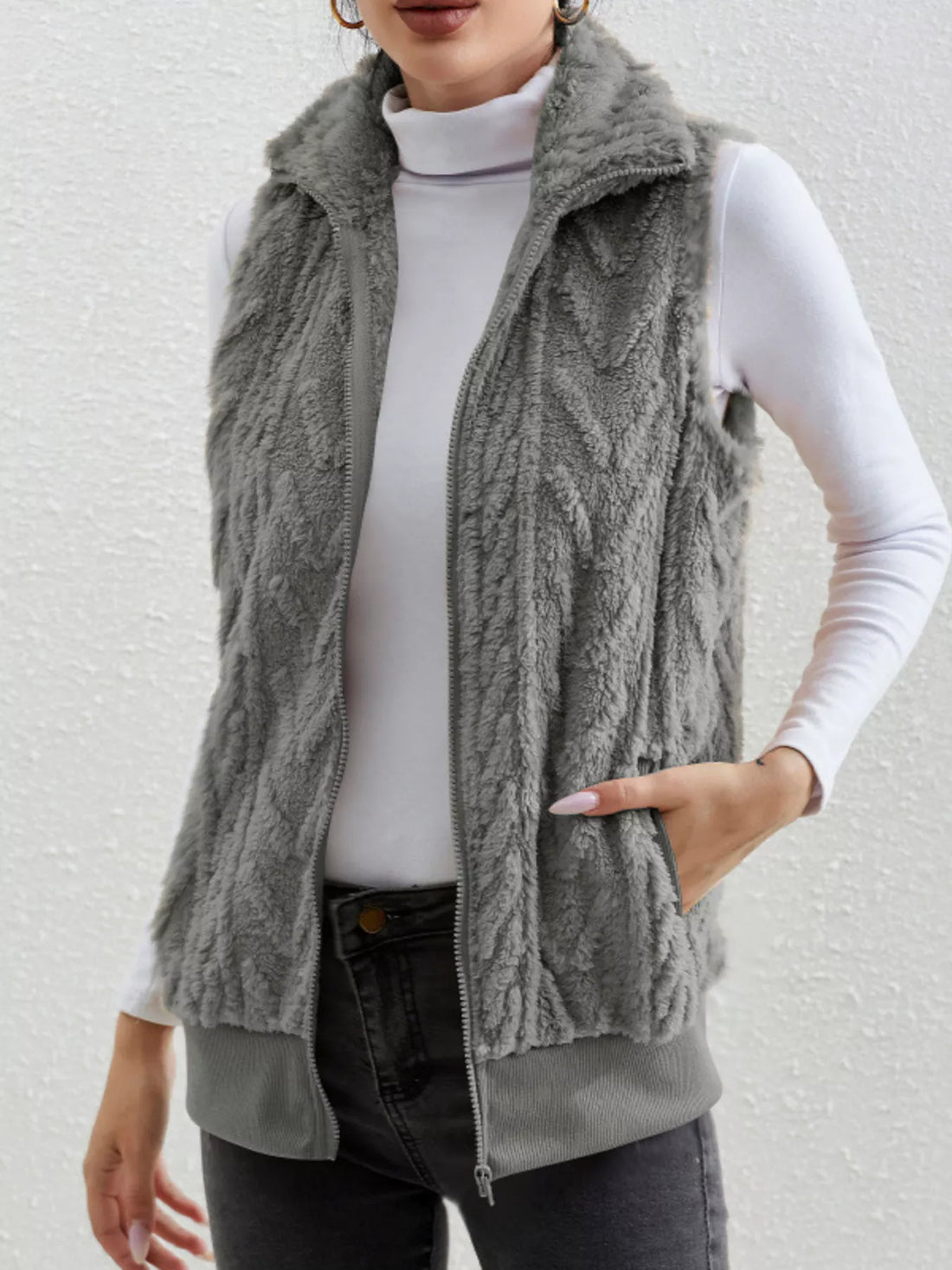 Cozy faux fur zip-up vest in dark gray with a textured pattern and stand-up collar.