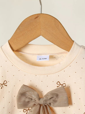 Tan baby set with polka dot print and large bow detail.