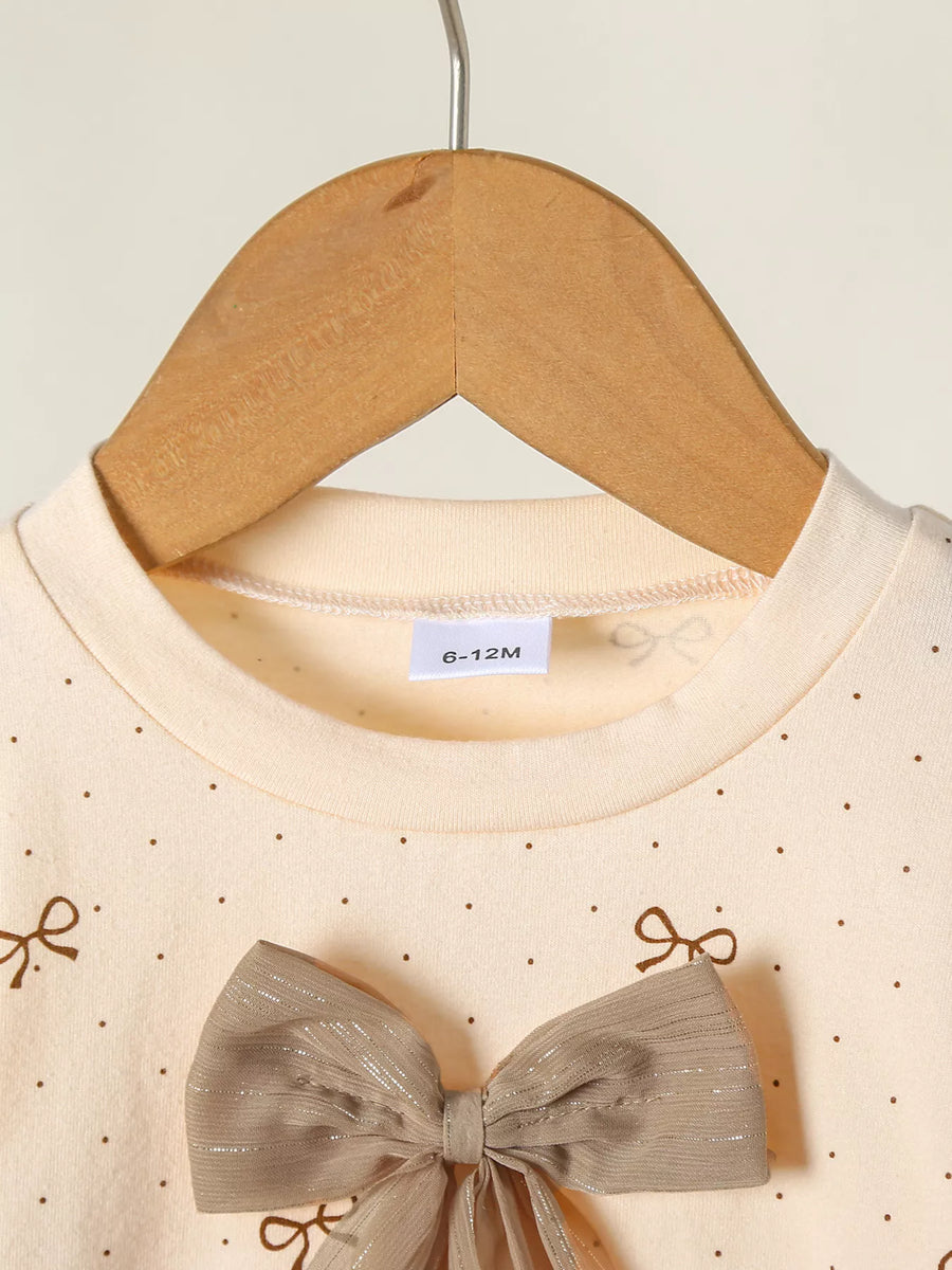 Tan baby set with polka dot print and large bow detail.