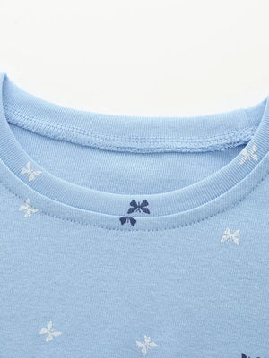 Cerulean cotton baby dress with allover butterfly and bow print.