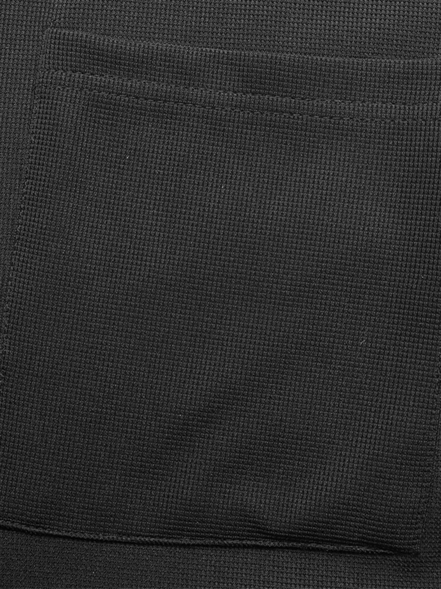 Black textured knit jumpsuit with a visible pocket detail.