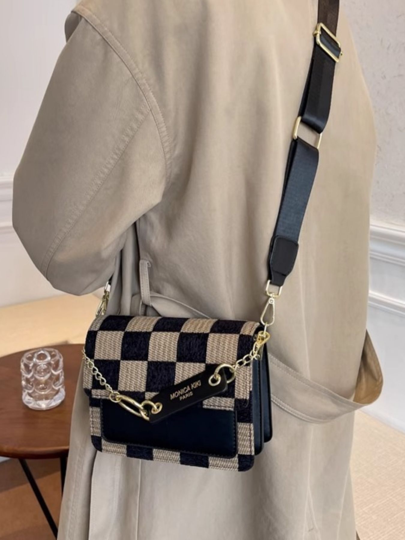 Mini checkered flap crossbody bag with adjustable strap and gold chain detail.