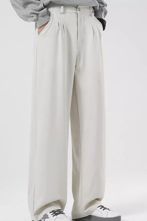 Men's cream pleated casual pants with a wide leg and relaxed fit.