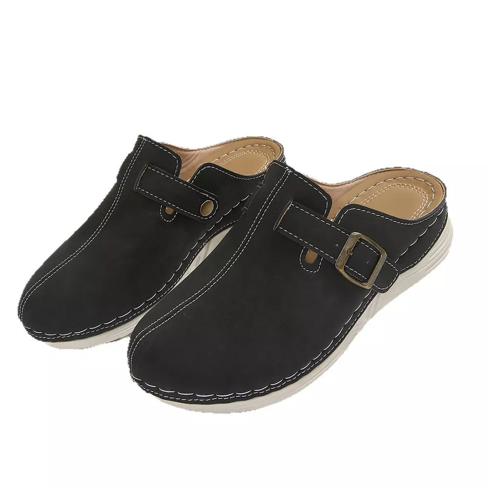 Black slip-on flats with buckle detail and contrast stitching